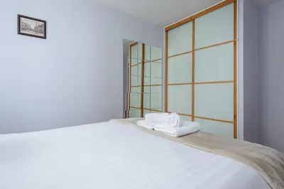 a bedroom with a bed with towels on it at Lovely Edinburgh Home - Craighouse Gardens in Edinburgh