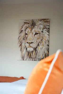 a painting of a lion hanging on a wall at 4 BDR House By Caledonia Luxe Stays Short Lets & Serviced Accommodation Livingston in Livingston