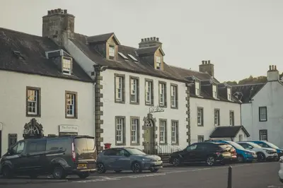 a group of cars parked in front of a building at NICHT' Apartments Inveraray Town Centre in Inveraray
