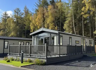 a modular home with a fence around it at Luxury Lodge
