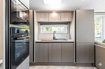 a kitchen with a sink and a window at Luxury Lodge
