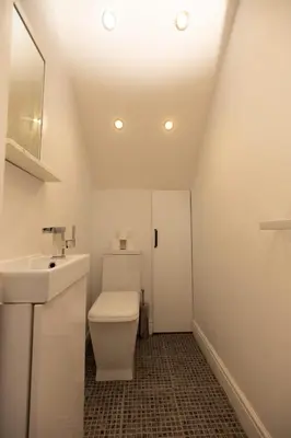 a bathroom with a toilet and a sink at Knightswood in Knightswood