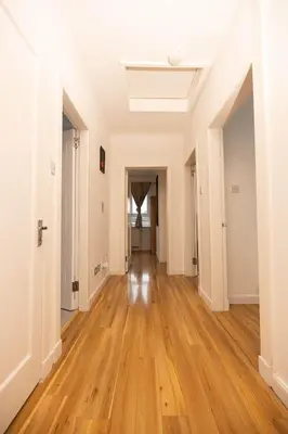 an empty hallway with wooden floors in an apartment at Knightswood in Knightswood