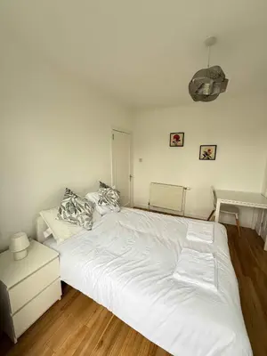 a bedroom with a large white bed in it at Knightswood in Knightswood