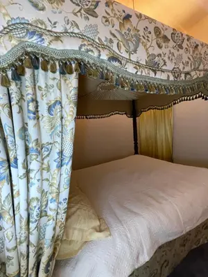a bedroom with a canopy bed with a white bedspread at Fordells Lodgings Stylish Rooms in Historic Townhouse in Inverkeithing