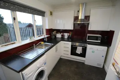 a small kitchen with a sink and a stove at Cheerful two bedroom home in Dunfermline in Dunfermline