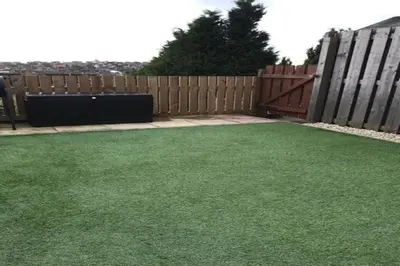 a backyard with a fence and green grass at Cheerful two bedroom home in Dunfermline in Dunfermline