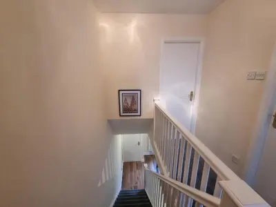 a staircase in a house with a picture on the wall at Cheerful two bedroom home in Dunfermline in Dunfermline