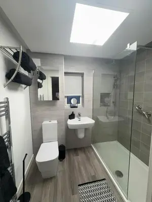 a bathroom with a toilet and a sink and a shower at Premium Village Stay near Train & Loch in Lochwinnoch