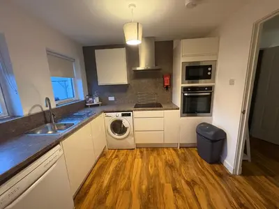 a kitchen with a sink and a washing machine at Premium Village Stay near Train & Loch in Lochwinnoch