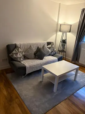 a living room with a couch and a coffee table at Premium Village Stay near Train & Loch in Lochwinnoch