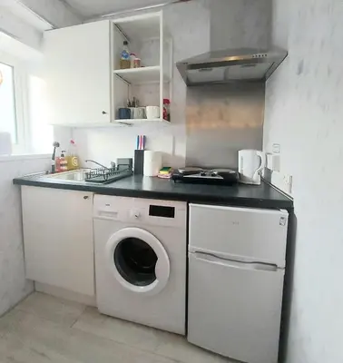 a kitchen with a washing machine and a dishwasher at The Wee Nest in Largs - One-Bedroom Ground Flat in Largs