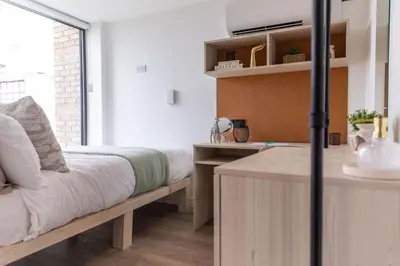 a bedroom with a bed and a desk and a window at For Students Only Martha Street Glasgow in Glasgow