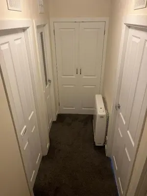 a hallway with a white door and a toilet at Flat in Oban town centre in Oban