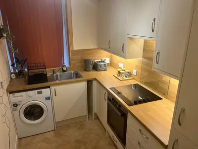 a kitchen with a sink and a washing machine at Flat in Oban town centre in Oban