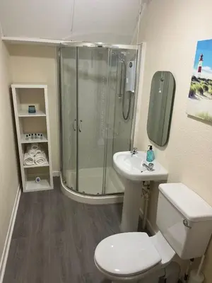 a bathroom with a shower and a toilet and a sink at Flat in Oban town centre in Oban