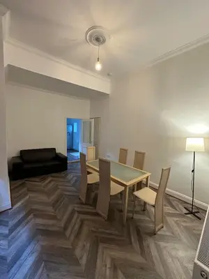 a dining room with a table and chairs at Victorian 5 Bedroom House Free Parking SSE Central in Glasgow