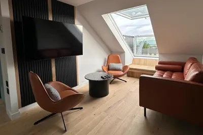 a living room with two chairs and a flat screen tv at 2-Bed - Sleeps 6 - Pet Friendly with Free Parking in Falkirk