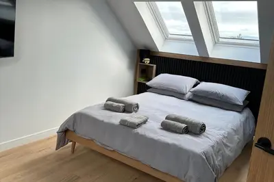 a bedroom with a bed with two pillows on it at 2-Bed - Sleeps 6 - Pet Friendly with Free Parking in Falkirk