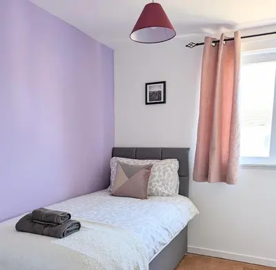 a bedroom with a bed and a window at Fairway house in Campbeltown