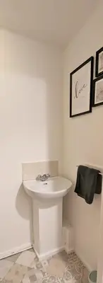 a bathroom with a white sink in a room at Fairway house in Campbeltown