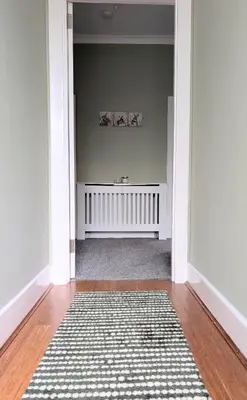 a hallway with a radiator and a rug at Whisky Row in Campbeltown
