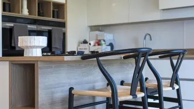two chairs sitting at a counter in a kitchen at Ardlui House Gardens in Hamilton