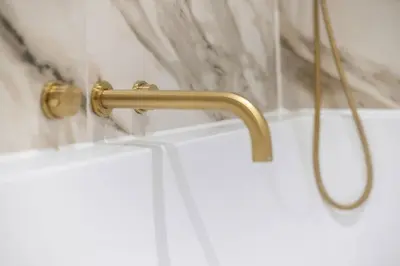a shower with a gold handle in a bathroom at The Kings Park Luxury Residence in Stirling