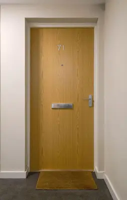 a wooden door in a room with a rug at The Stirling Penthouse - Free Parking in Stirling