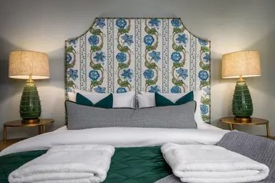 a bedroom with a large bed with two lamps at Ledi Lookout Callander in Stirling
