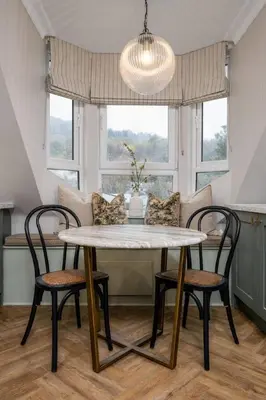 a dining room with a table and two chairs at Ledi Lookout Callander in Stirling