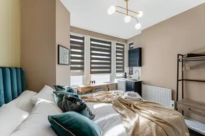 a bedroom with a bed with pillows on it at Stylish Studio Retreat in Ideal Location in Moffat