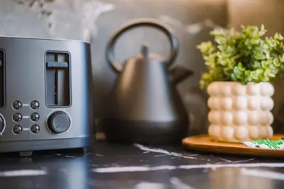 a tea kettle on a counter next to a toaster at JW Executive ApartHouse in Glasgow