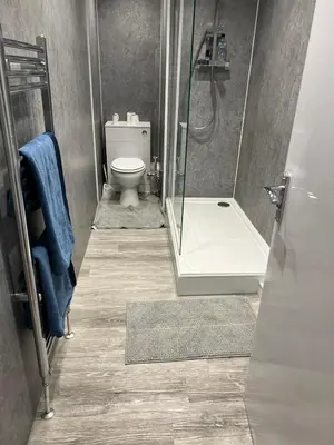 a bathroom with a toilet and a glass shower at Perfect Stay Near Glasgow Town in Glasgow