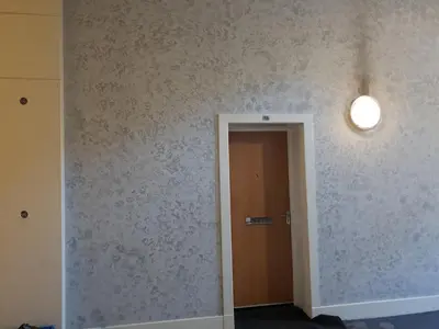 a hallway with a door and a light on a wall at Perfect Stay Near Glasgow Town in Glasgow