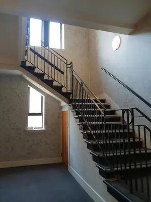 an empty room with stairs in a building at Perfect Stay Near Glasgow Town in Glasgow