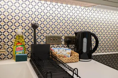 a kitchen counter with a coffee maker on a counter top at Luxury Flat Near Hove Station parking sleeps 4 in Moffat