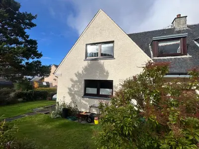 a white house with a gambrel roof at 29 Carnoch, Glencoe Village in Glencoe
