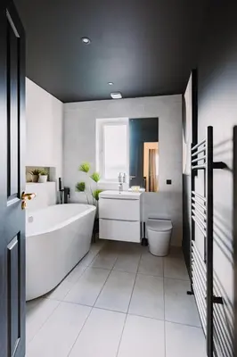 a bathroom with a tub and a toilet and a sink at JW Executive ApartHouse 2 in Glasgow