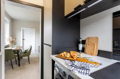 a kitchen with a counter with bread and a table at Modern 3 Bedroom home in Kings Park in Polmadie