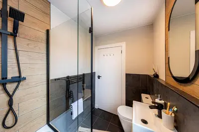 a bathroom with a sink and a glass shower at Modern 3 Bedroom home in Kings Park in Polmadie