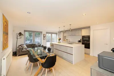 a kitchen and living room with a glass table at Chic Edinburgh 3-Bedroom 2-Storey House near City Centre with Free Parking in Edinburgh