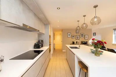 a kitchen with white counters and a counter top at Chic Edinburgh 3-Bedroom 2-Storey House near City Centre with Free Parking in Edinburgh