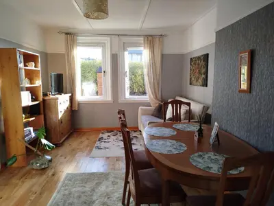 a living room with a table and chairs and a couch at Lovely place at Stenhouse in Edinburgh