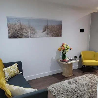 a living room with a couch and a table at Riverside Apartment in Moffat