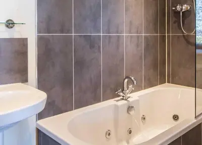 a bathroom with a sink and a bath tub at Spacious holiday home with stunning sea views in Whiting Bay