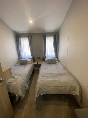 two beds in a small room with two windows at Wemyss Bay Mapleton Elite in Wemyss Bay