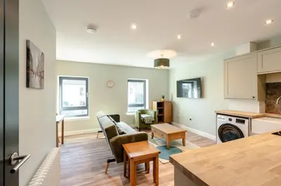 a living room with a couch and a table at Stunning upper villa stay in the City! in Edinburgh