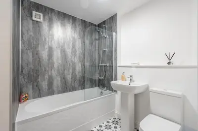 a white bathroom with a sink and a tub and a toilet at Stunning upper villa stay in the City! in Edinburgh