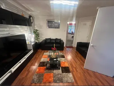 a living room with a couch and a table at Stylish 3 bedroom house in Glasgow